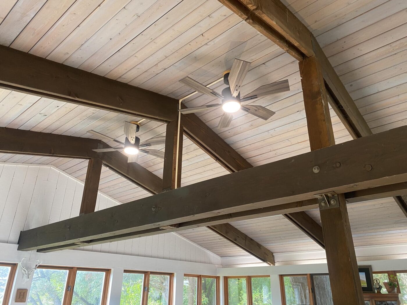 Two fans in tall a-frame room
